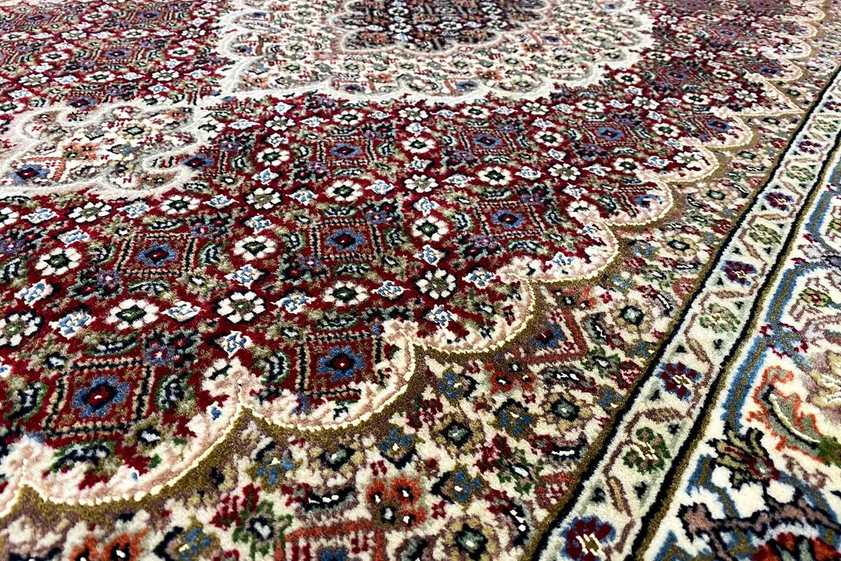 Indo-Tabriz carpet: Detail with red medallion and floral ornaments