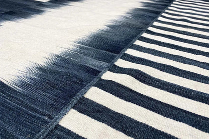 Modern kilim (170x240 cm) with dark blue and white stripes and woven sections