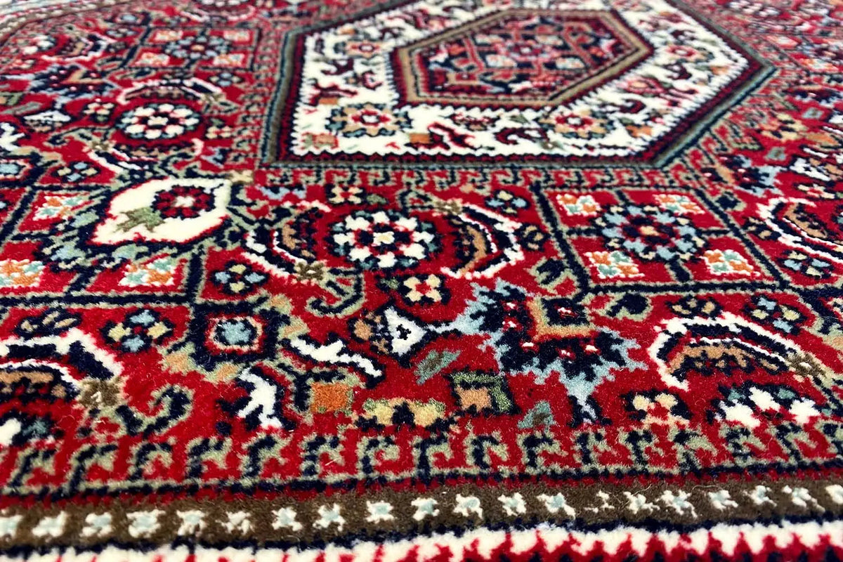 Bidjar rug (93x61 cm) with detailed pattern in red, blue, and white, close-up view