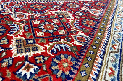 Bidjar runner with a multicolored carpet pattern and border, close-up from the side