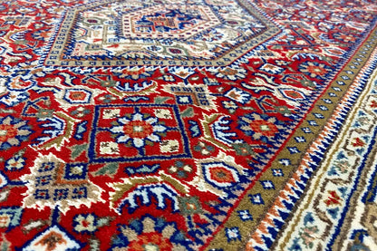 Bidjar runner with red center, blue border band, and medallion patterns, detail view