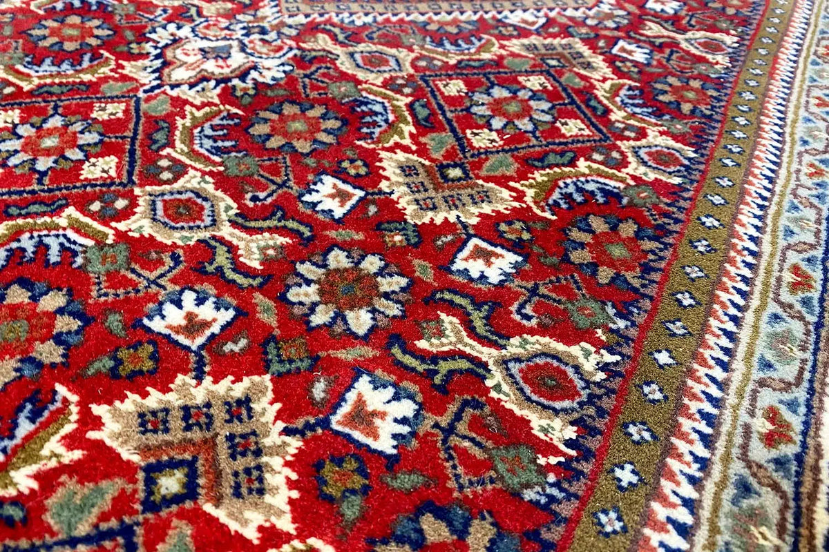 Bidjar runner with a colorful medallion pattern, burgundy background, and fine borders.
