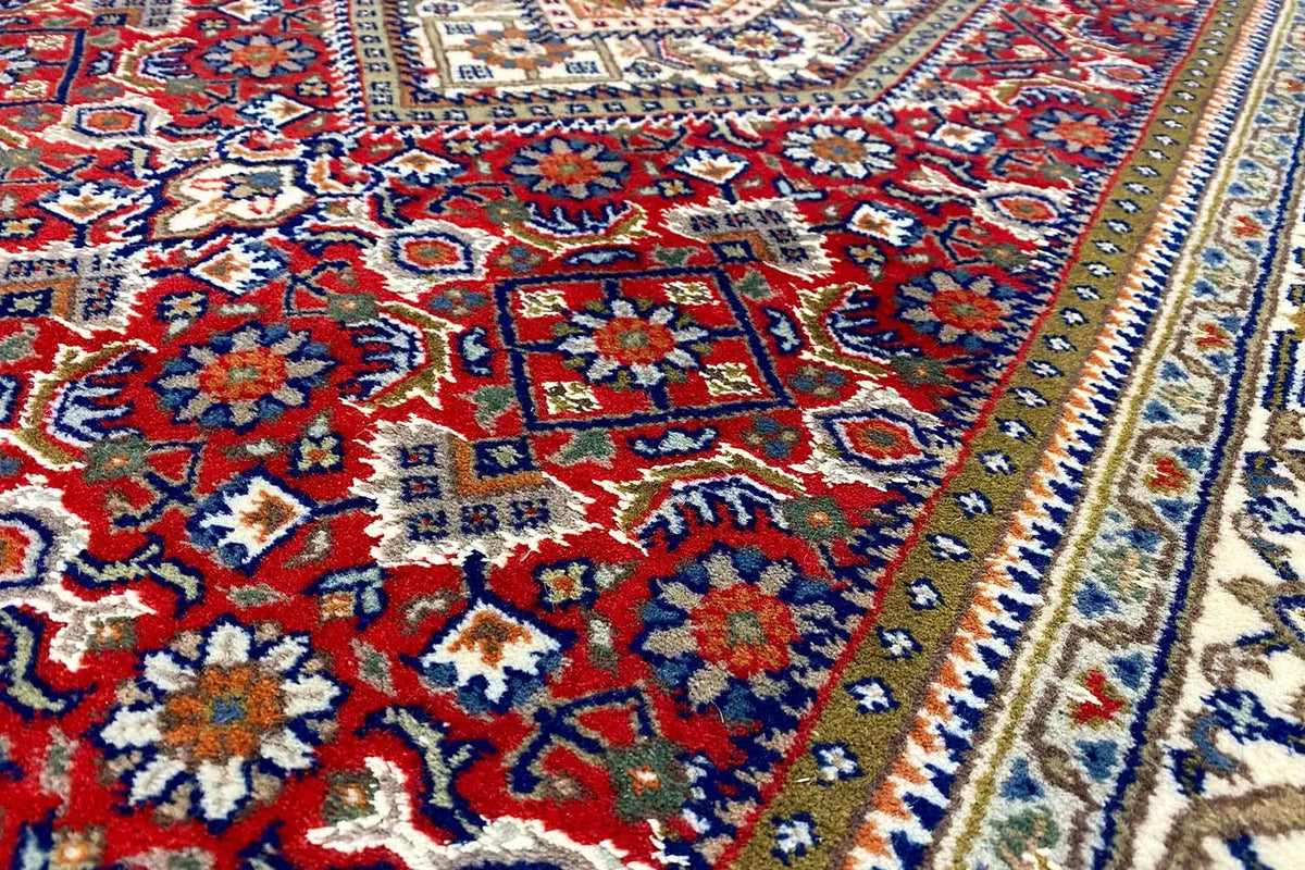 Bidjar runner rug with a colorful medallion pattern in red, blue, and cream (close-up)