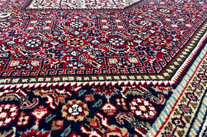 Close-up of a Bidjar carpet: geometric ornaments in red, blue, and dark blue