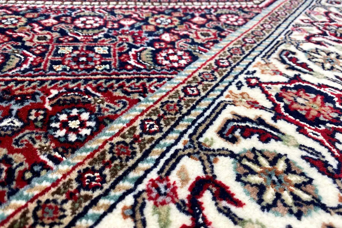 Bidjar carpet with a red medallion and blue-and-white patterns, close-up