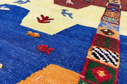 Close-up of a colorful kilim pattern with zigzag and animal motifs