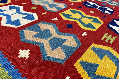 Kilim rug detail with zigzag patterns and color blocks in red and blue
