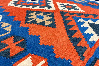 Kilim rug pattern of diamonds and zigzags in orange, blue and cream