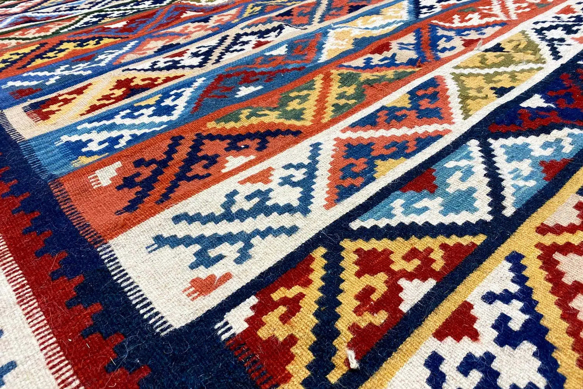 Kilim rug: colorful geometric pattern, close-up of the ornaments and edge.