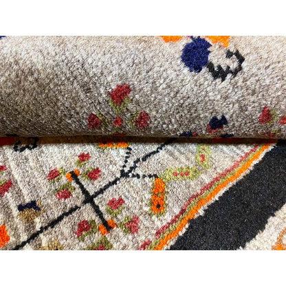 Carpet detail: gray pile surface with colorful patterns and a dark border strip