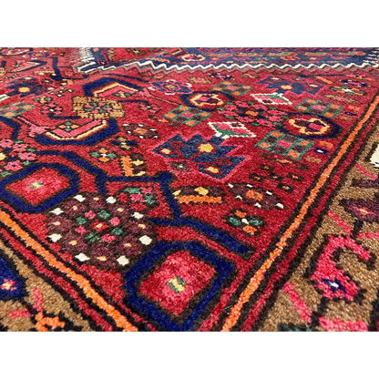 Hamadan rug with a red, blue, and green ornamental pattern and a wide border trim