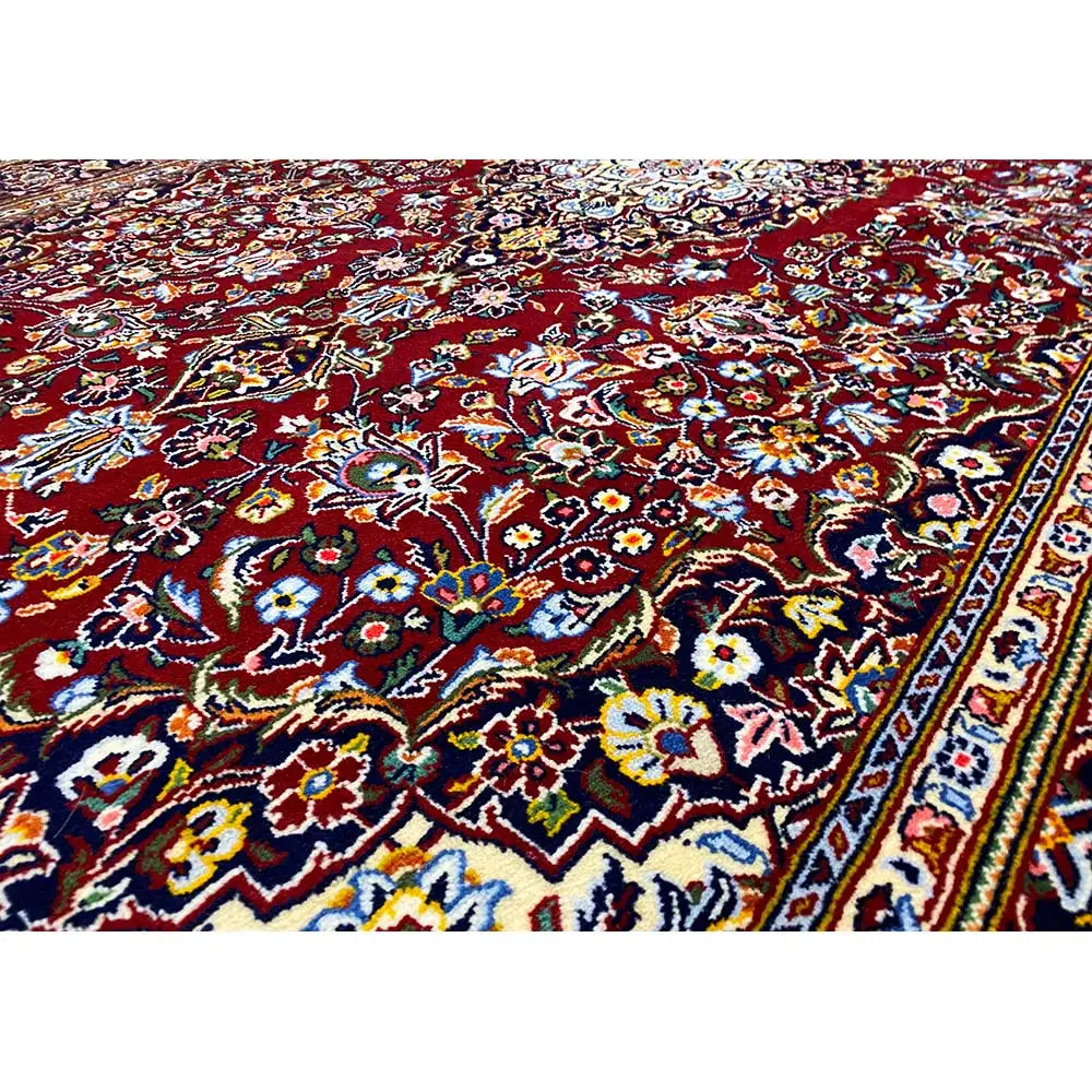 Keshan rug with an ornamental border pattern in dark red and blue, motif detail