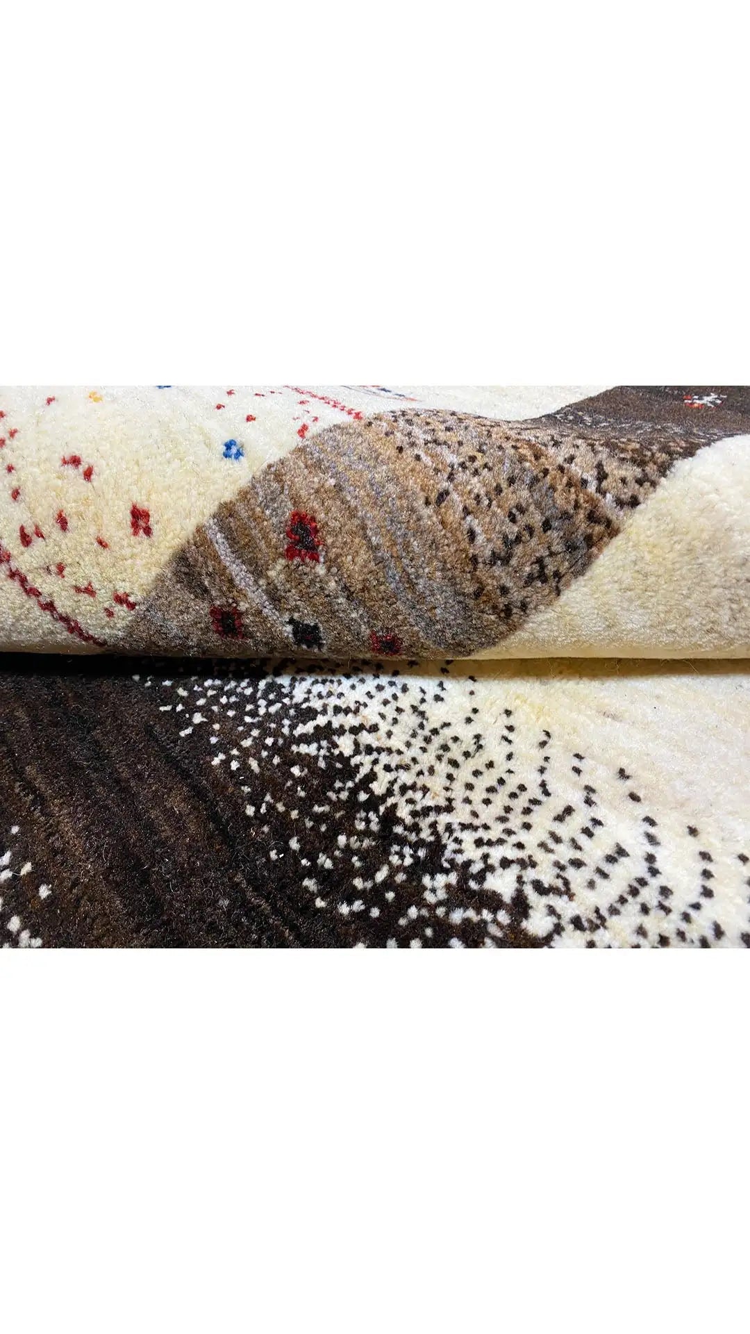 Gabbeh rug with a cream-colored pattern, dark edges and colorful accents