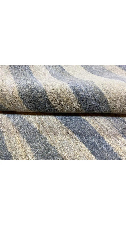 Gabbeh rug detail: wavy stripe patterns in blue, gray, and beige