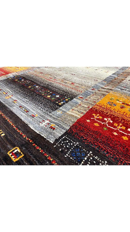 Rug with Gabbeh pattern: gray, red, and yellow ornaments on a dark background
