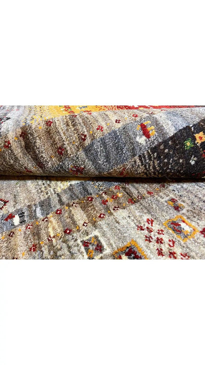 Rug surface with a Gabbeh pattern: gray base with colorful, small pattern dots