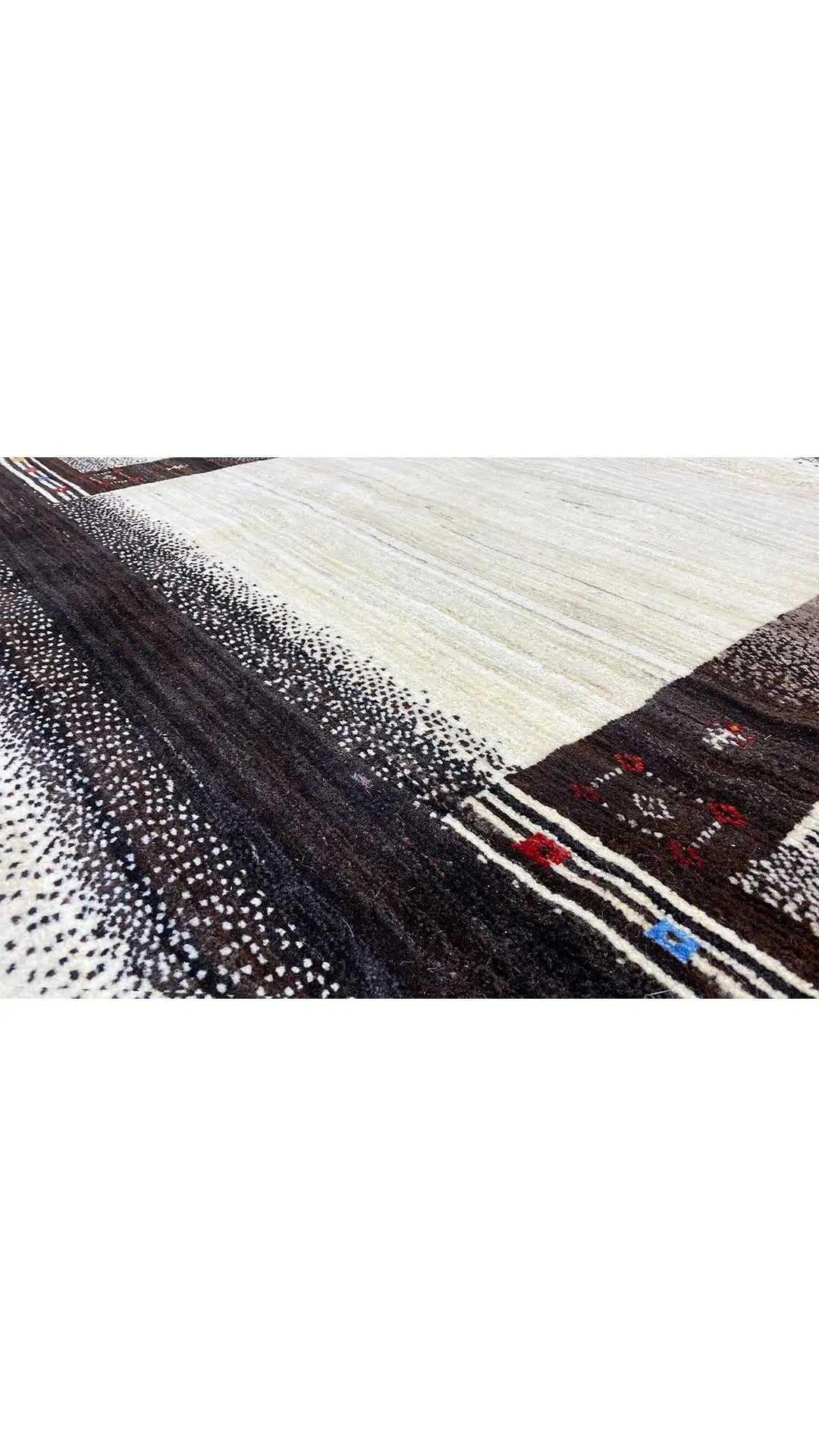 Rug with a light center stripe and dark brown border, patterned with small color accents