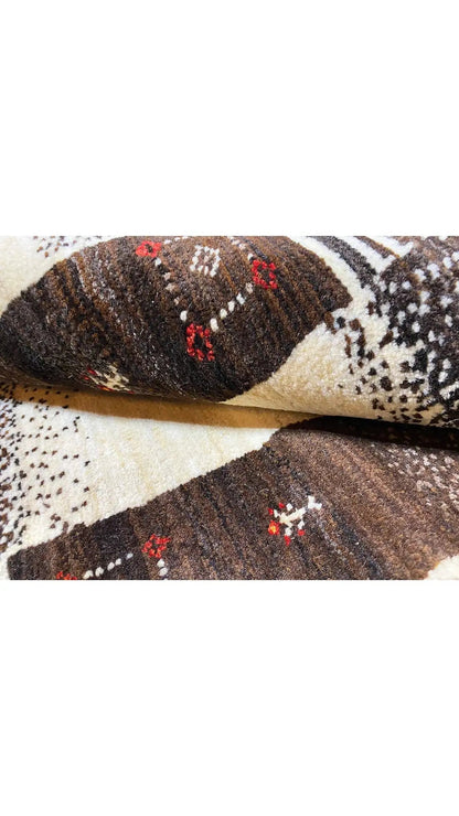 Rug corner with a twisted border, cream-colored base, and dark brown patterned areas