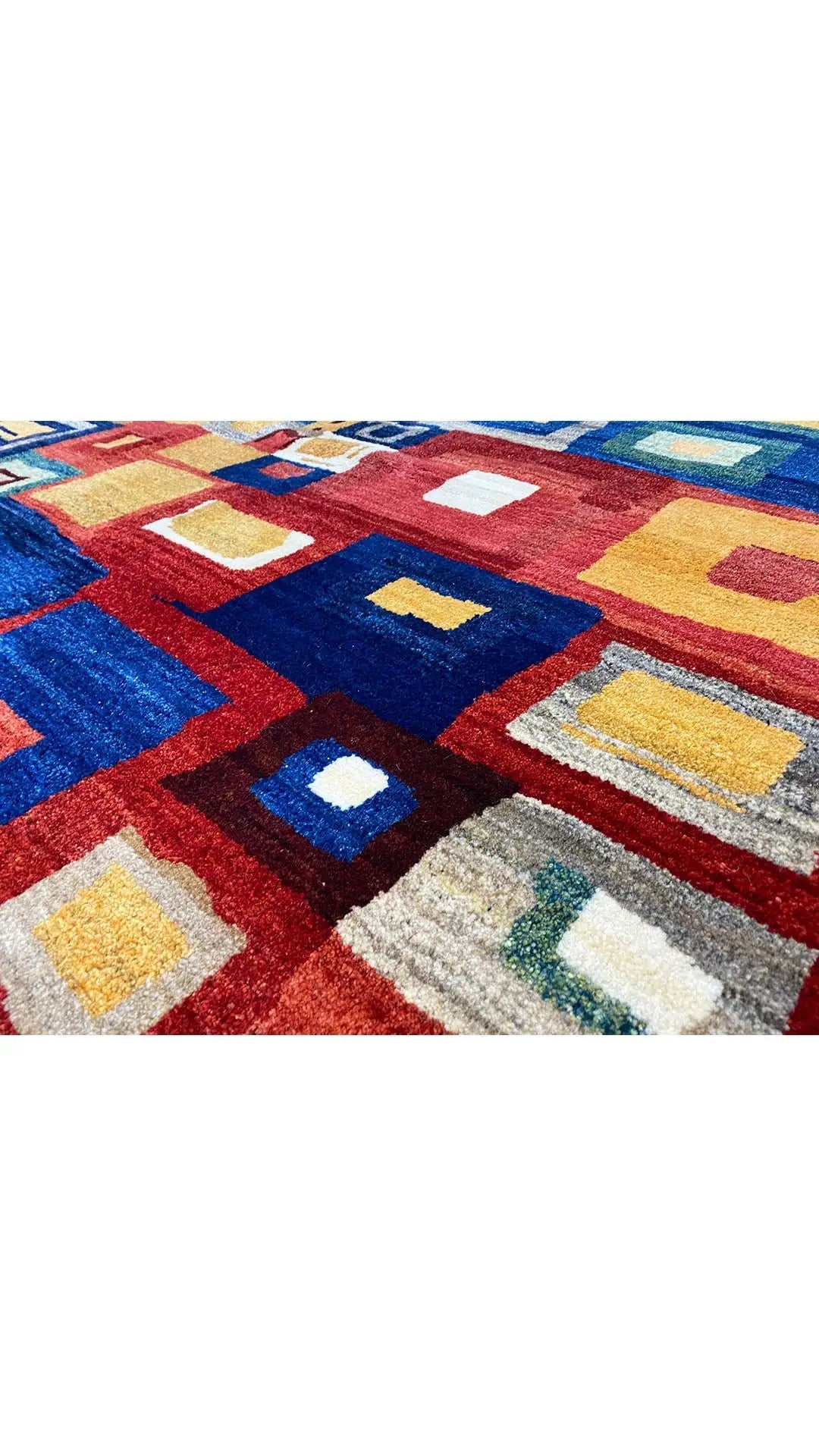 Gabbeh rug with a geometric pattern in red, blue, yellow, and cream