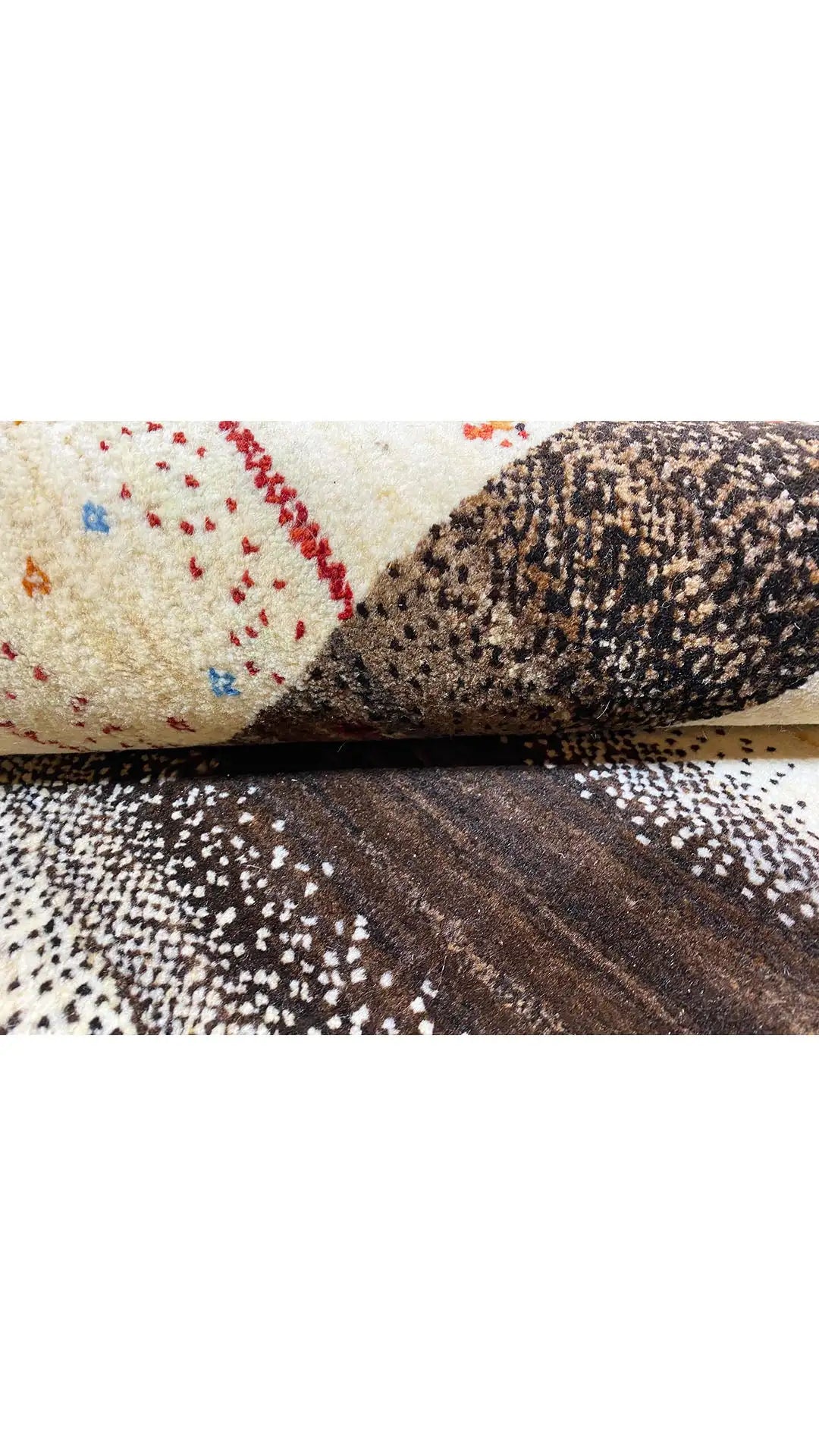 Gabbeh rug with a cream-colored area, dark brown, and a black-and-white dotted pattern