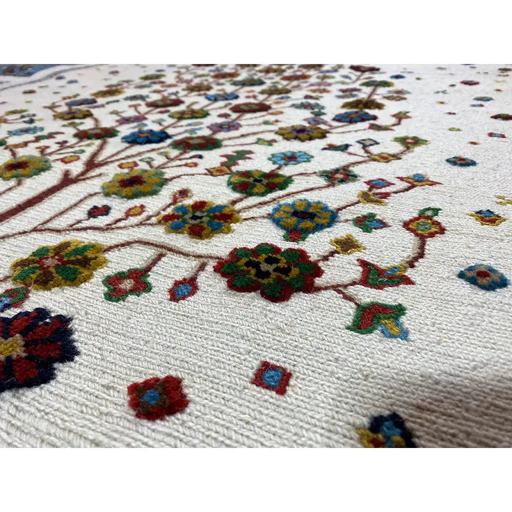 Rug with a light background and colorful floral patterns, detailed embroidered look