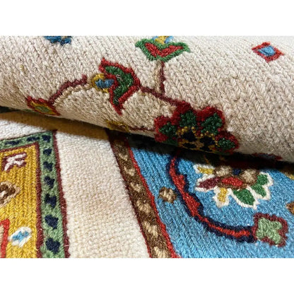 Carpet border with multicolored ornaments and an inserted striped border in blue