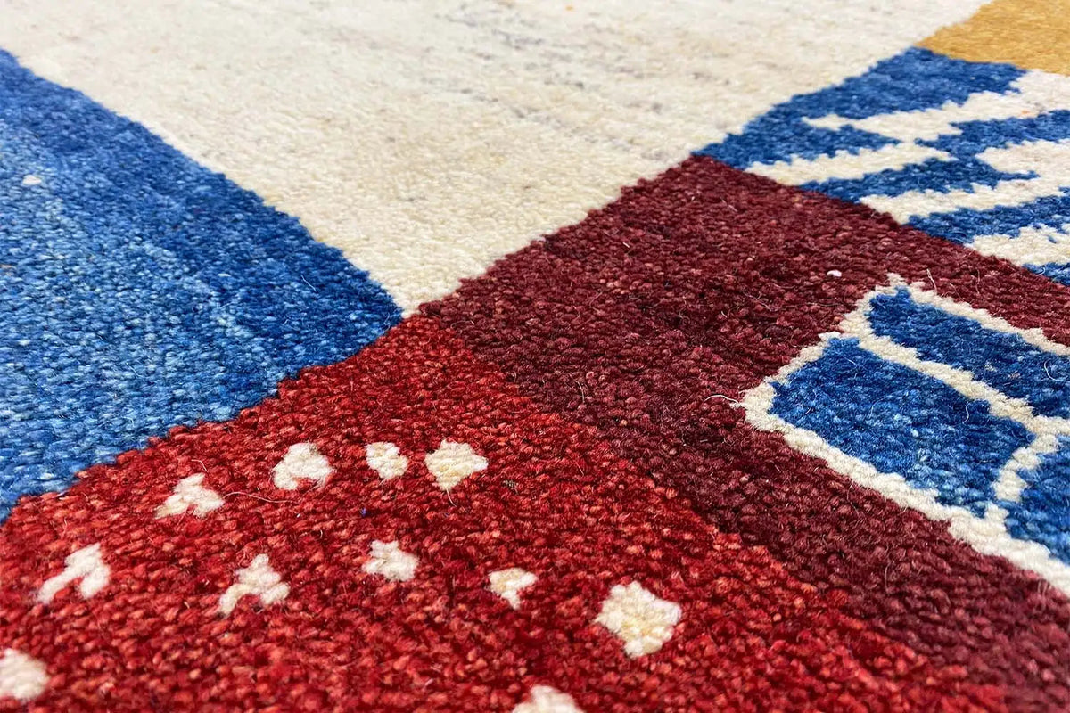 Gabbeh rug: red pattern with blue diamonds on a cream background