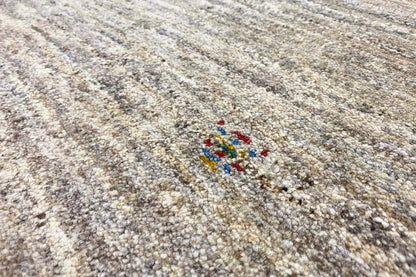 Gabbeh rug with a beige pile and multicolored decorative motif