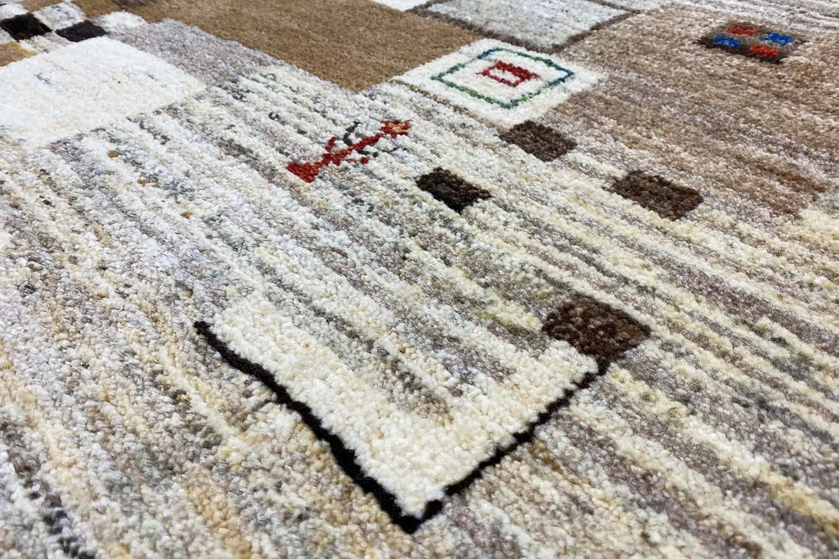 Gabbeh rug with a beige mottled pile, stripes and geometric motifs