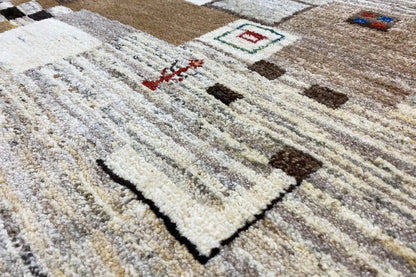 Gabbeh rug with a beige mottled pile, stripes and geometric motifs
