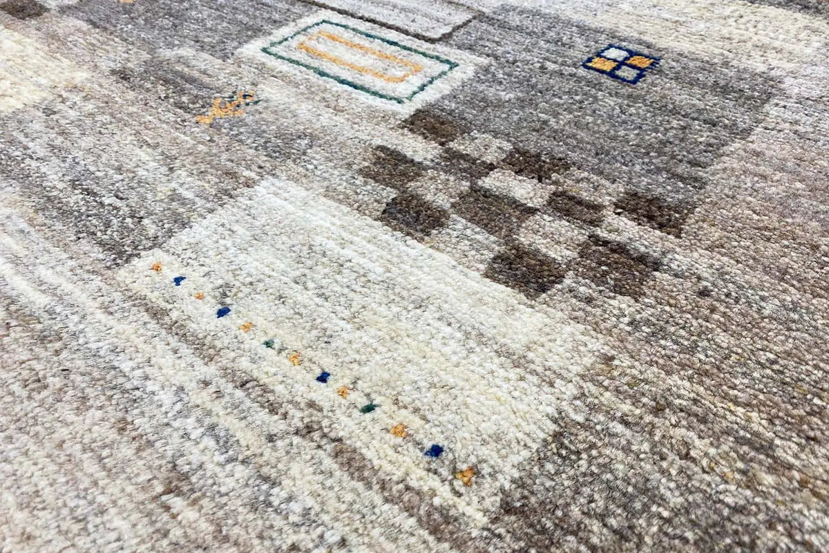 Gabbeh rug (193x156 cm) with an abstract pattern in beige and gray, close-up
