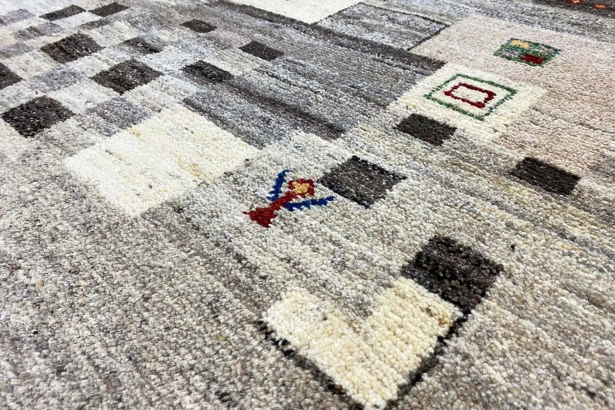 Gabbeh rug 204x150 cm with a geometric pattern in gray, black, and cream.