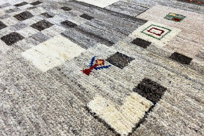 Gabbeh rug 204x150 cm with a geometric pattern in gray, black, and cream.