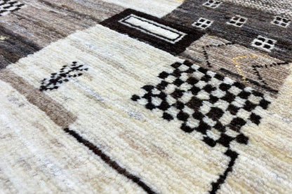 Gabbeh rug with a light background and black diamond and square pattern