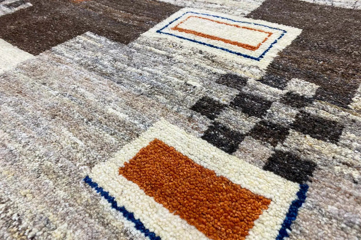 Gabbeh rug, close-up with a light background, orange field, and blue border