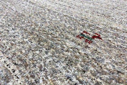 Gabbeh rug with a beige-gray pattern and red/blue medallion