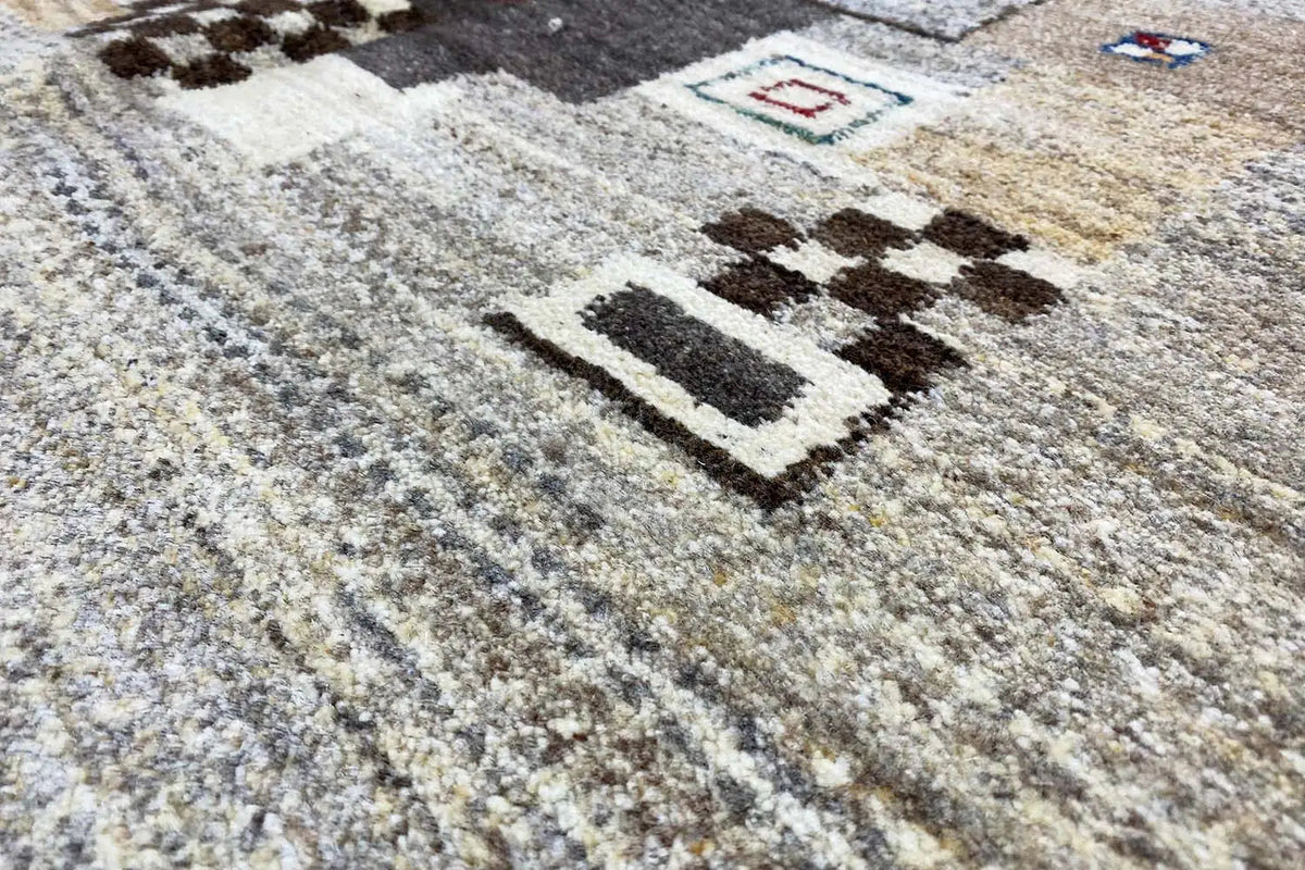 Gabbeh rug with gray low pile and a dark geometric-patterned border