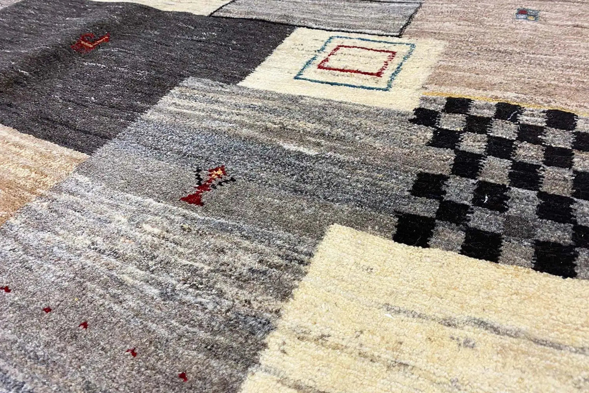 Gabbeh rug, mottled gray pile with patchwork motifs in black and beige