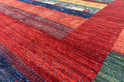 Gabbeh-Lori rug with red, blue, and green areas, textured pile