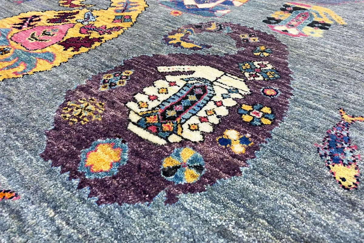 Gabbeh Lori rug with ornaments, a blue-gray background, and colorful medallions