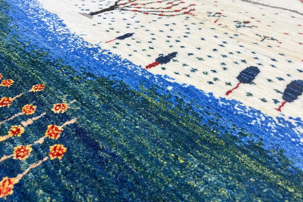 Gabbeh rug with a blue stripe and tree motifs, pile in close-up