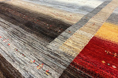 Rug detail with woven stripes in gray, beige, yellow, and red; fine patterns