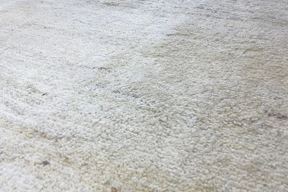 Gabbeh rug in light beige with a dense pile surface, close-up view