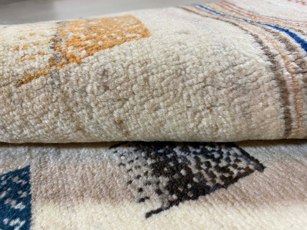 Gabbeh rug with beige pile and multicolored geometric rectangles, detailed stitching