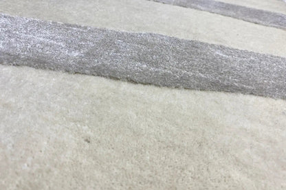 Rug with horizontal stripes in beige and gray, close-up of the pattern