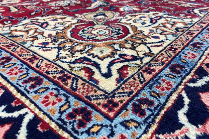 Khorasan carpet: ornamental pattern in red, cream, and dark blue (close-up).