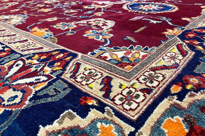 Bakhtiari rug: maroon background with a floral vine pattern, colorful border (close-up)