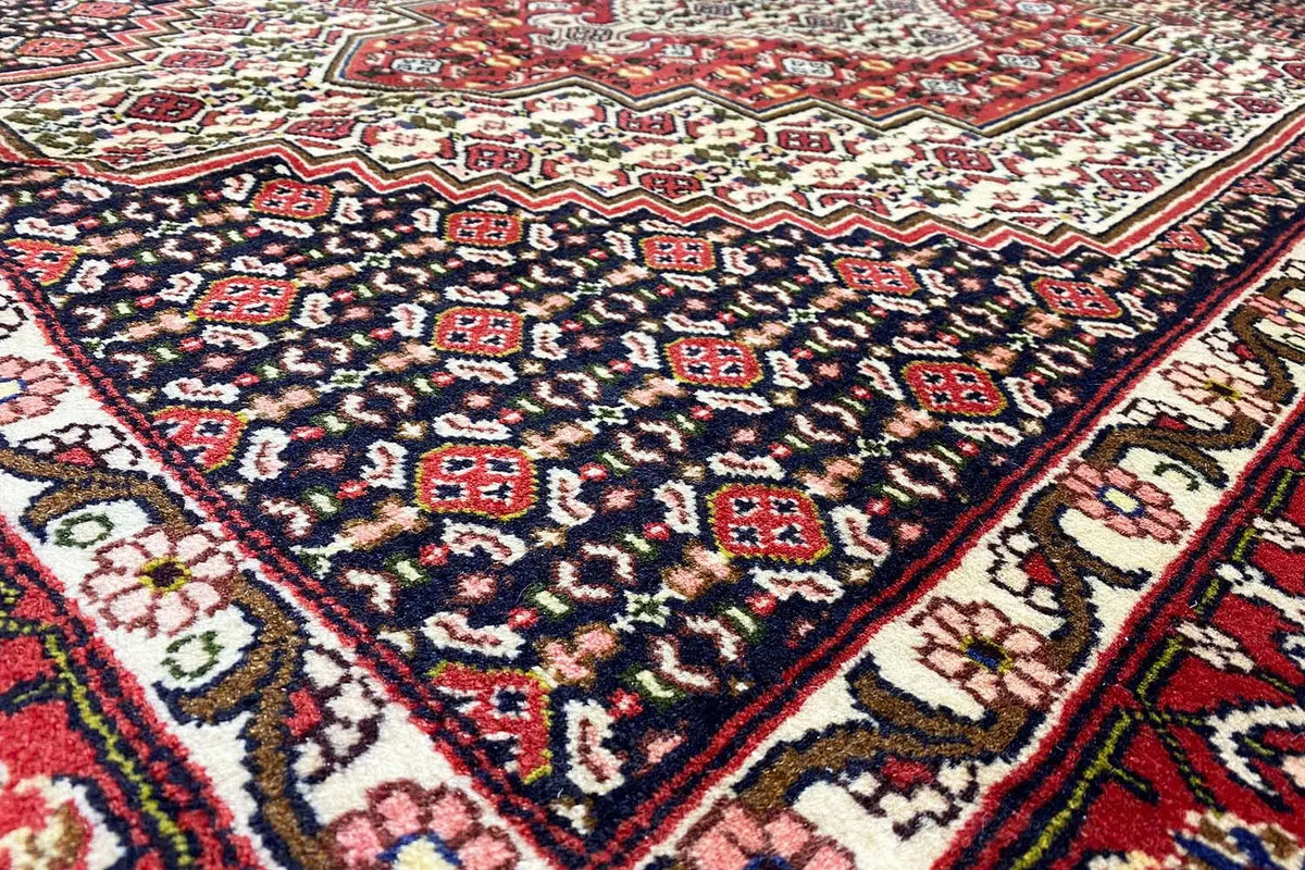 Hamadan carpet: dark blue pattern with red ornaments (close-up)