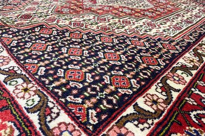 Hamadan carpet: dark blue pattern with red ornaments (close-up)