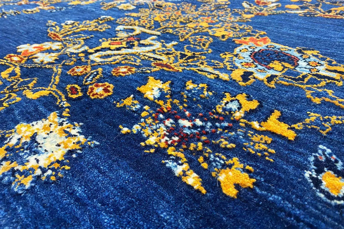Blue Gabbeh rug with a colorful yellow ornament pattern, close-up of the pile texture